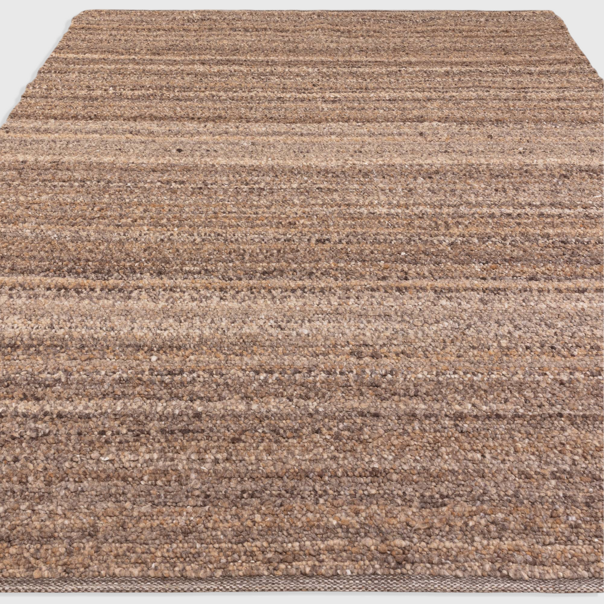 Alvo Rugs Abella tawny brown hand-woven boucle rug with a textured boho aesthetic and soft polyester flatweave pile.
