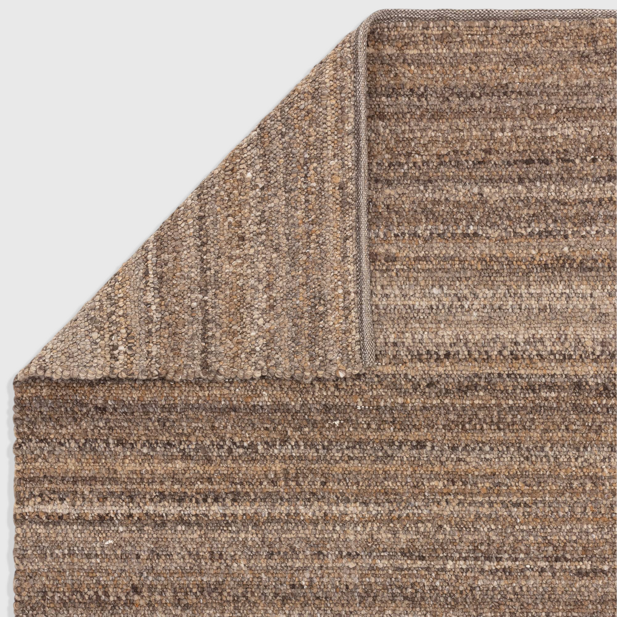 Alvo Rugs Abella tawny brown hand woven polyester boucle rug with a textured boho flatweave pile and folded corner