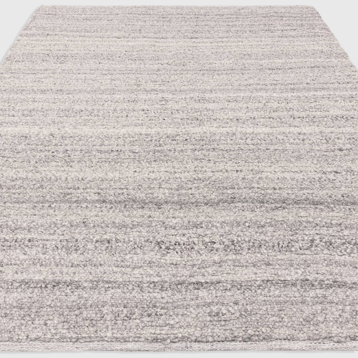 Alvo Rugs Abella Steel grey boucle rug with a textured hand-woven flatweave design and boho aesthetic.