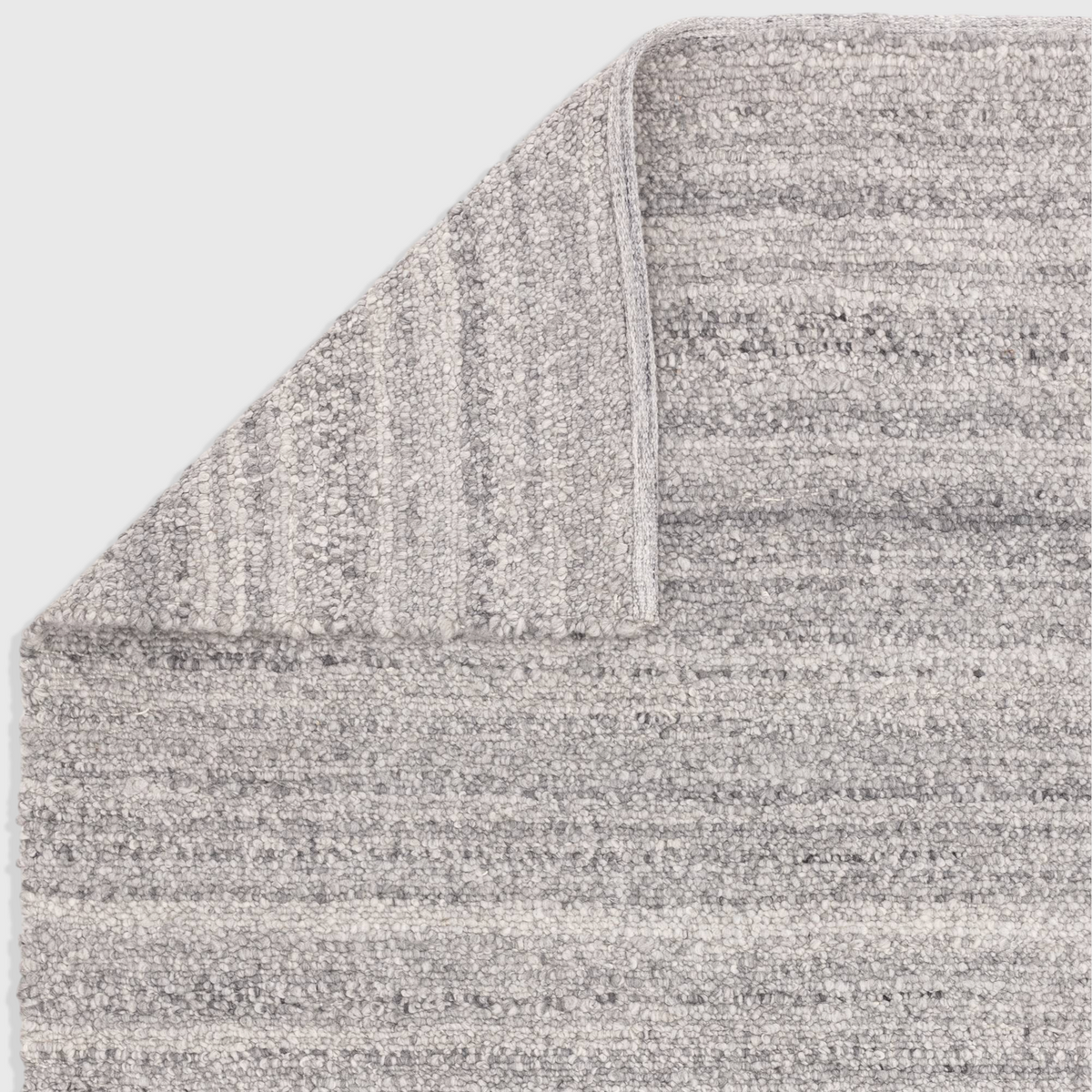 Alvo Rugs Abella Steel grey hand-woven polyester boucle rug with a textured boho flatweave design and corner detail