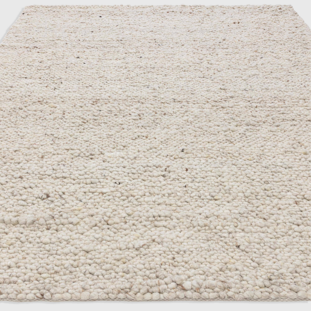 Alvo Rugs Adio ivory wool rug with a chunky hand-woven boucle texture and soft cream loop pile finish.