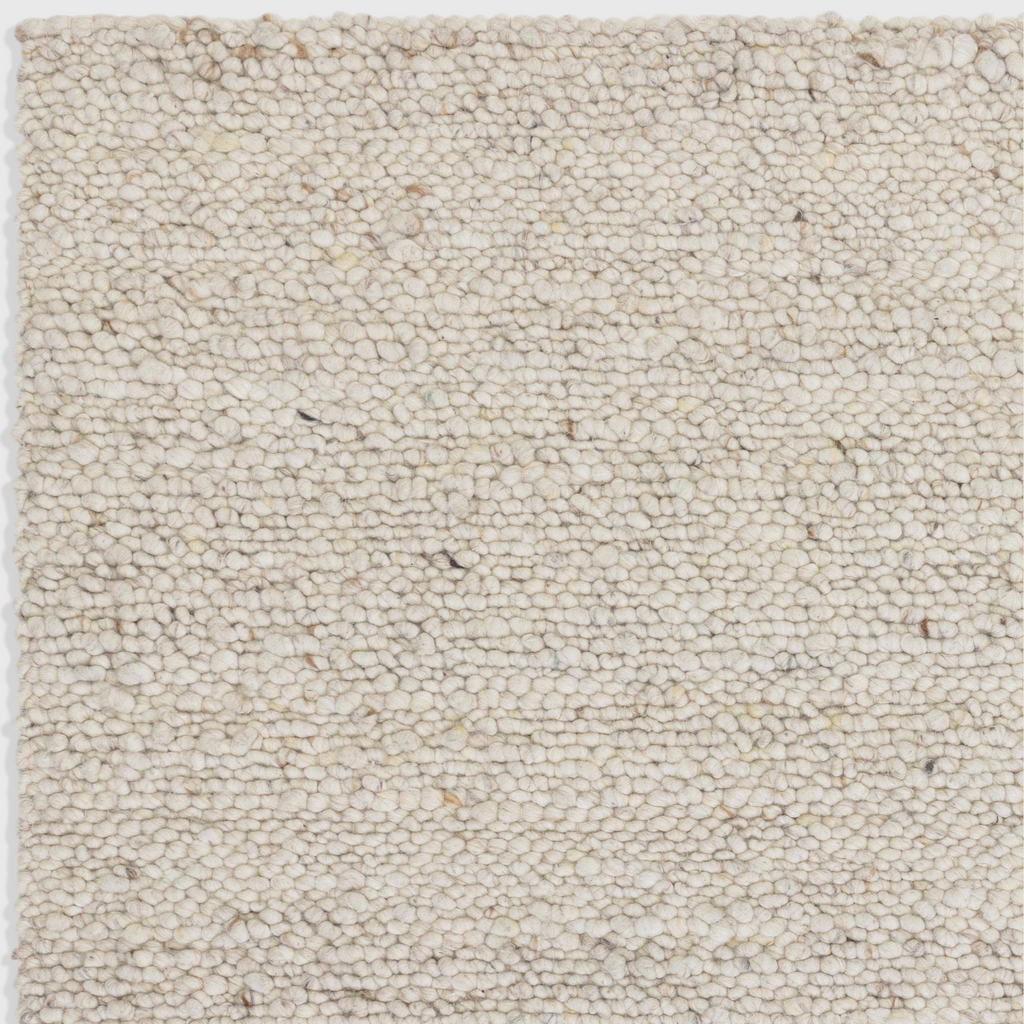 Alvo Rugs Adio ivory wool rug featuring a chunky hand-woven boucle loop pile texture in soft cream tones.