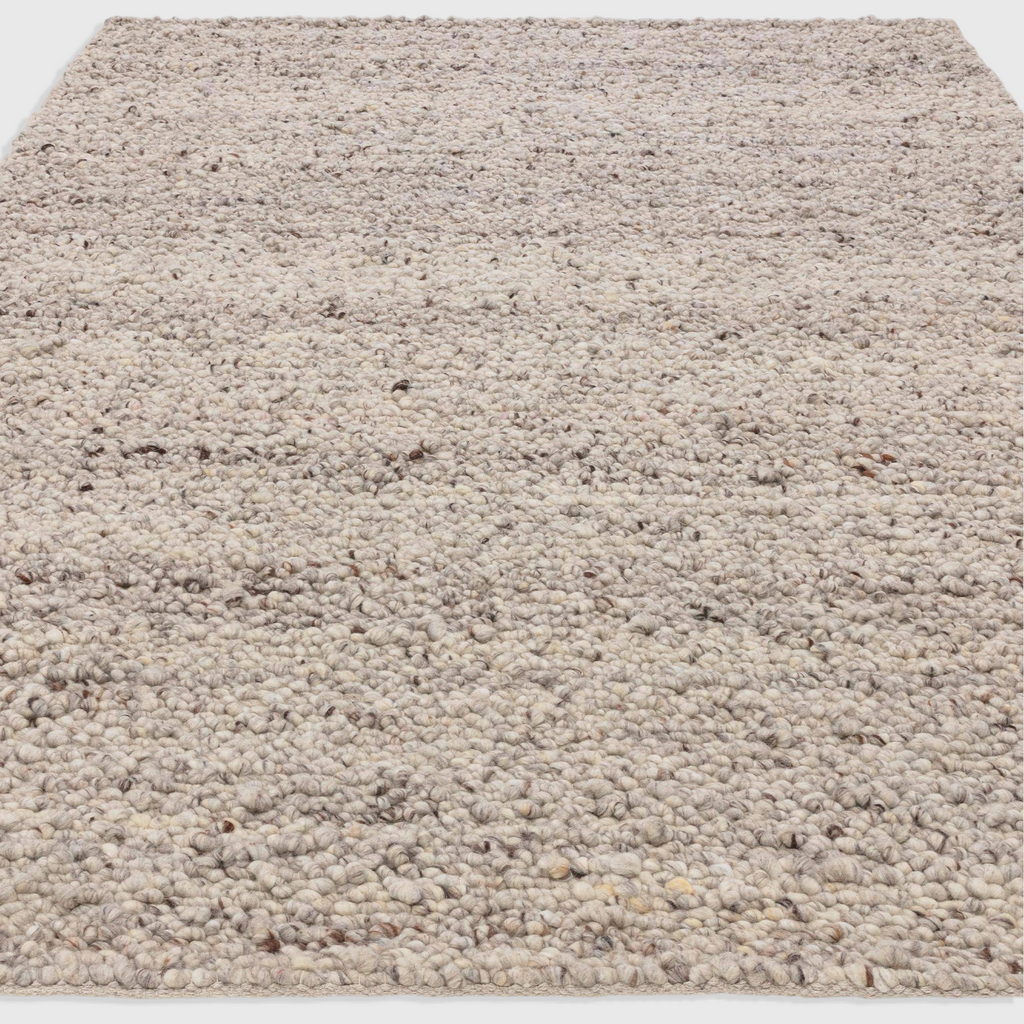 Alvo Rugs Adio silver hand-woven wool rug with a chunky boucle loop pile texture in soft grey and neutral tones.