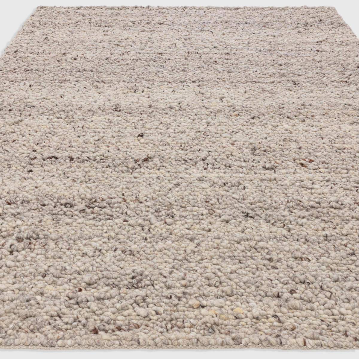 Alvo Rugs Adio silver hand-woven wool rug with a chunky boucle loop pile texture in soft grey and neutral tones.