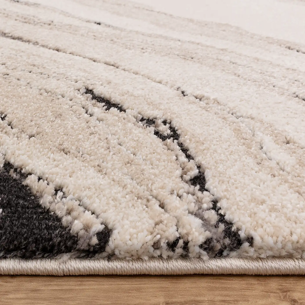 Alvo Rugs Miraga Quartz beige shaggy rug with high-low pile and abstract natural patterns on a wooden floor