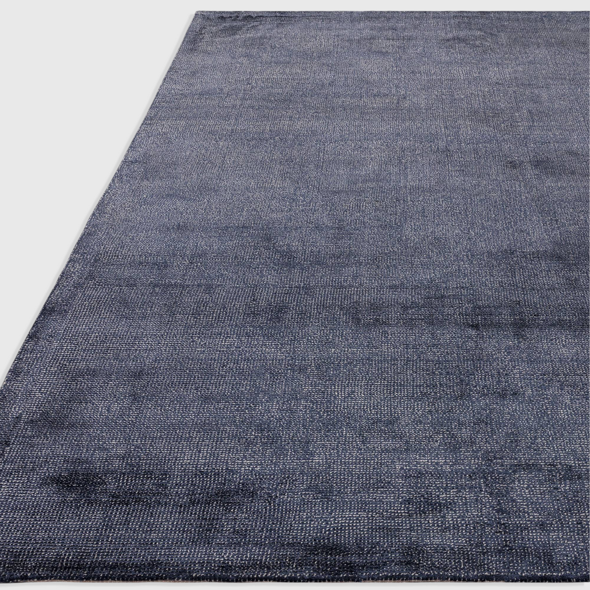 Alvo Rugs Astonia navy blue hand-woven viscose rug with a subtle sheen and textured loop pile finish.