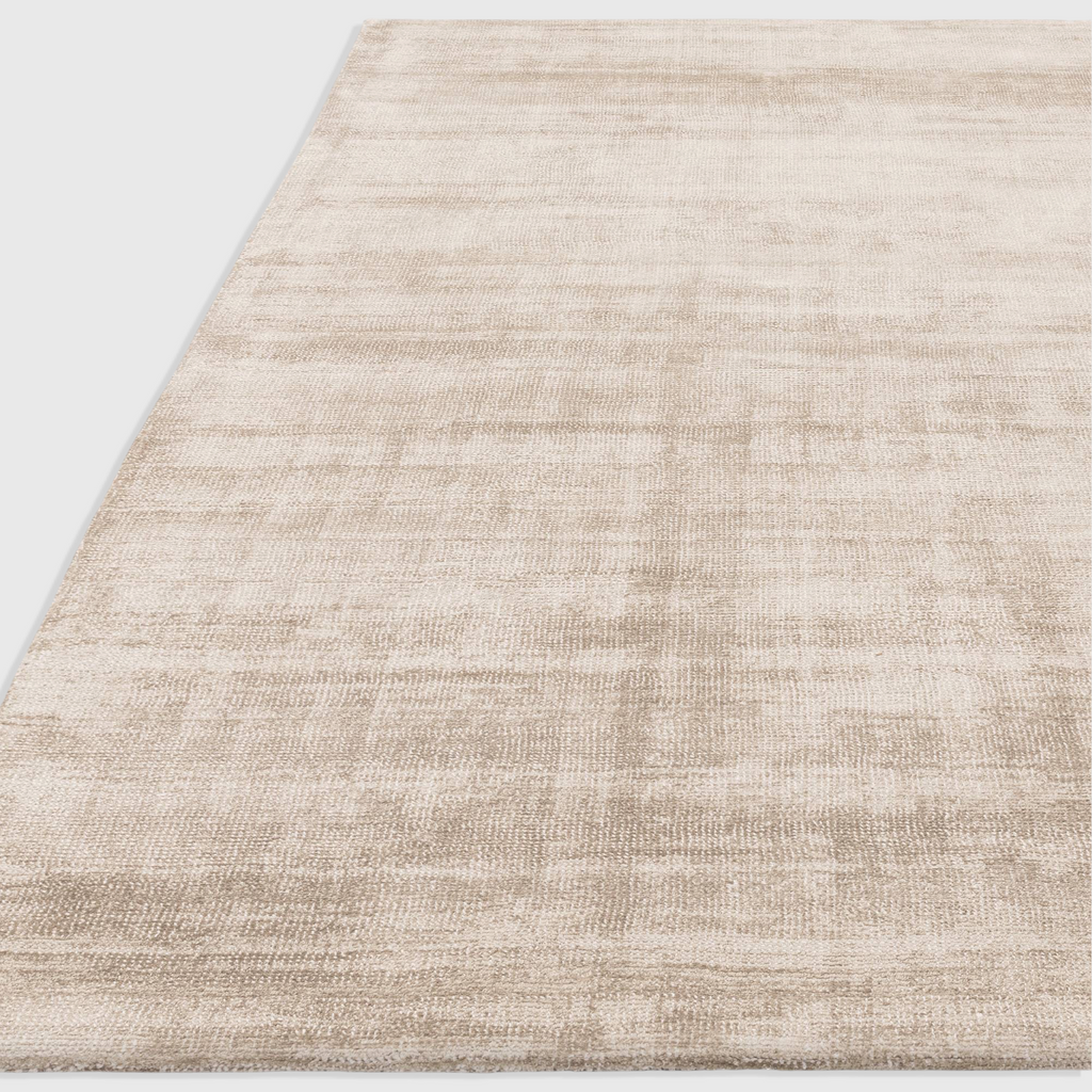 Alvo Rugs Astonia sand beige hand-woven viscose rug with a subtle sheen and loop pile texture.
