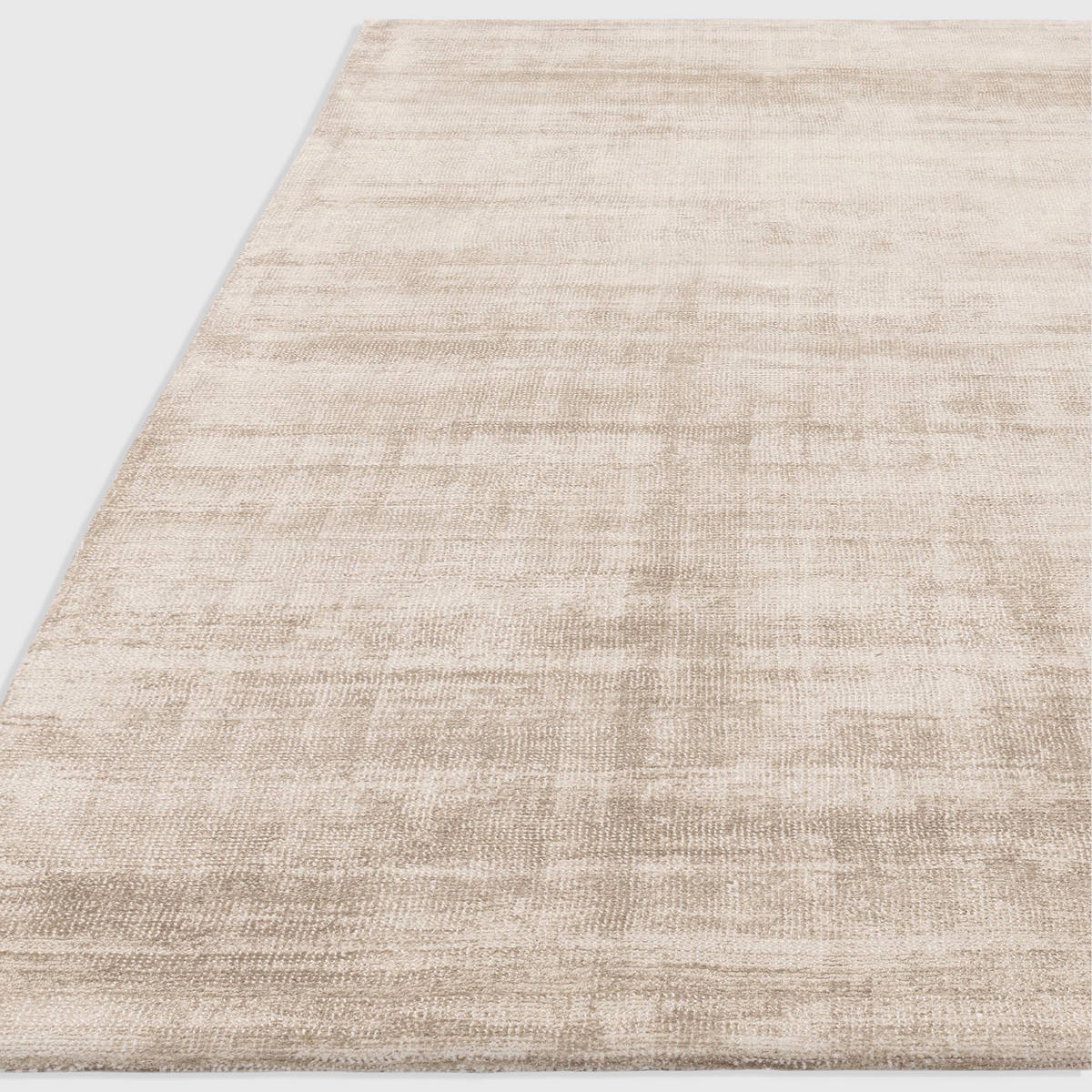 Alvo Rugs Astonia sand beige hand-woven viscose rug with a subtle sheen and loop pile texture.