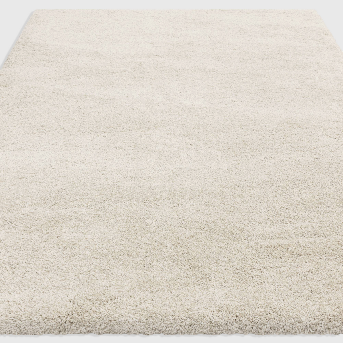 Alvo Rugs Atelier ivory shaggy rug with a thick, dense pile and soft cream polypropylene texture.