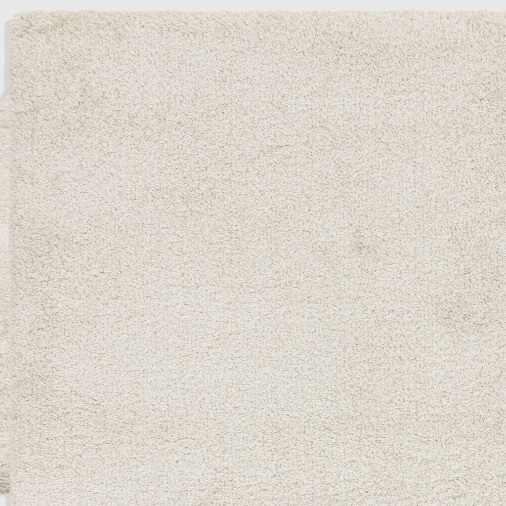 Alvo Rugs Atelier ivory shaggy rug with a thick, plush 4.5cm pile made from soft polypropylene.