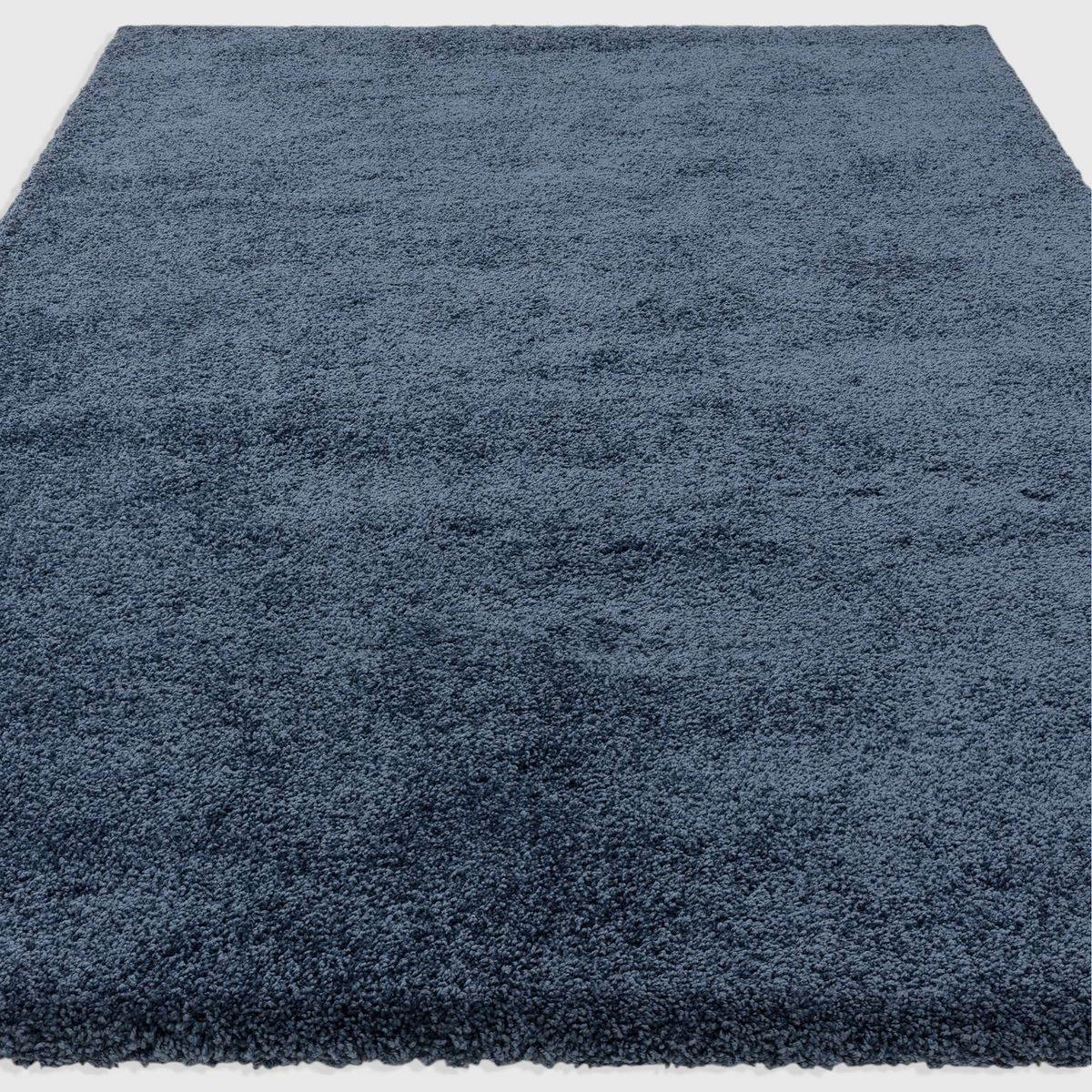 Alvo Rugs Atelier navy blue shaggy rug with a thick, plush pile and soft polypropylene texture.