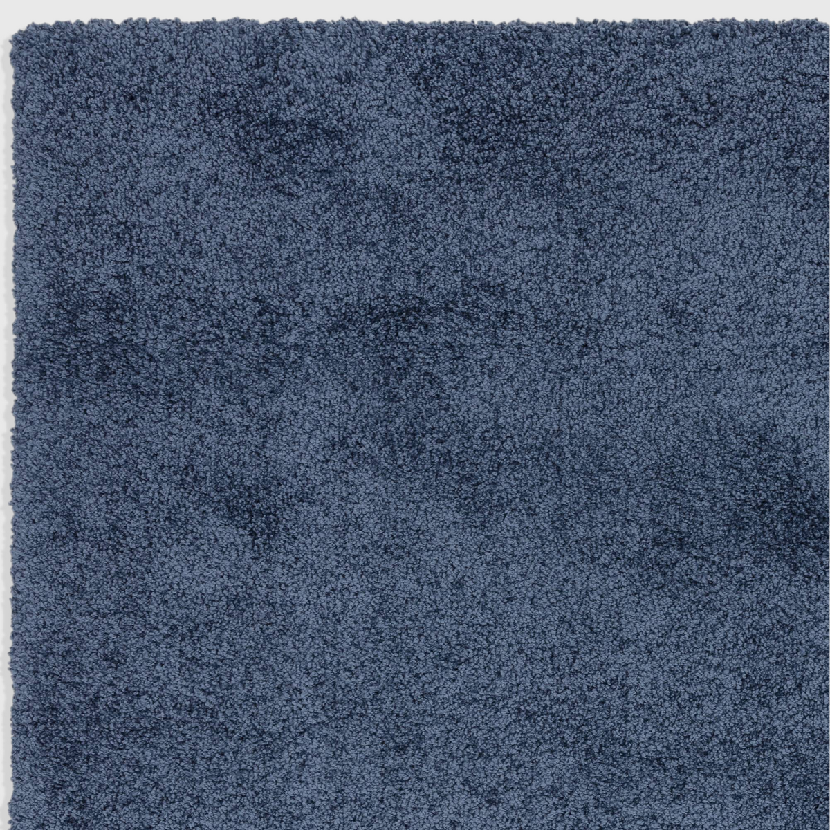 Alvo Rugs Atelier navy blue shaggy rug with a thick, dense polypropylene pile and soft textured surface.