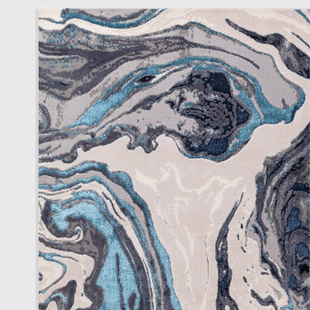 Alvo Rugs Aurorella Ocean Au18 abstract rug featuring swirling blue, grey, and metallic tones in a soft cut pile.