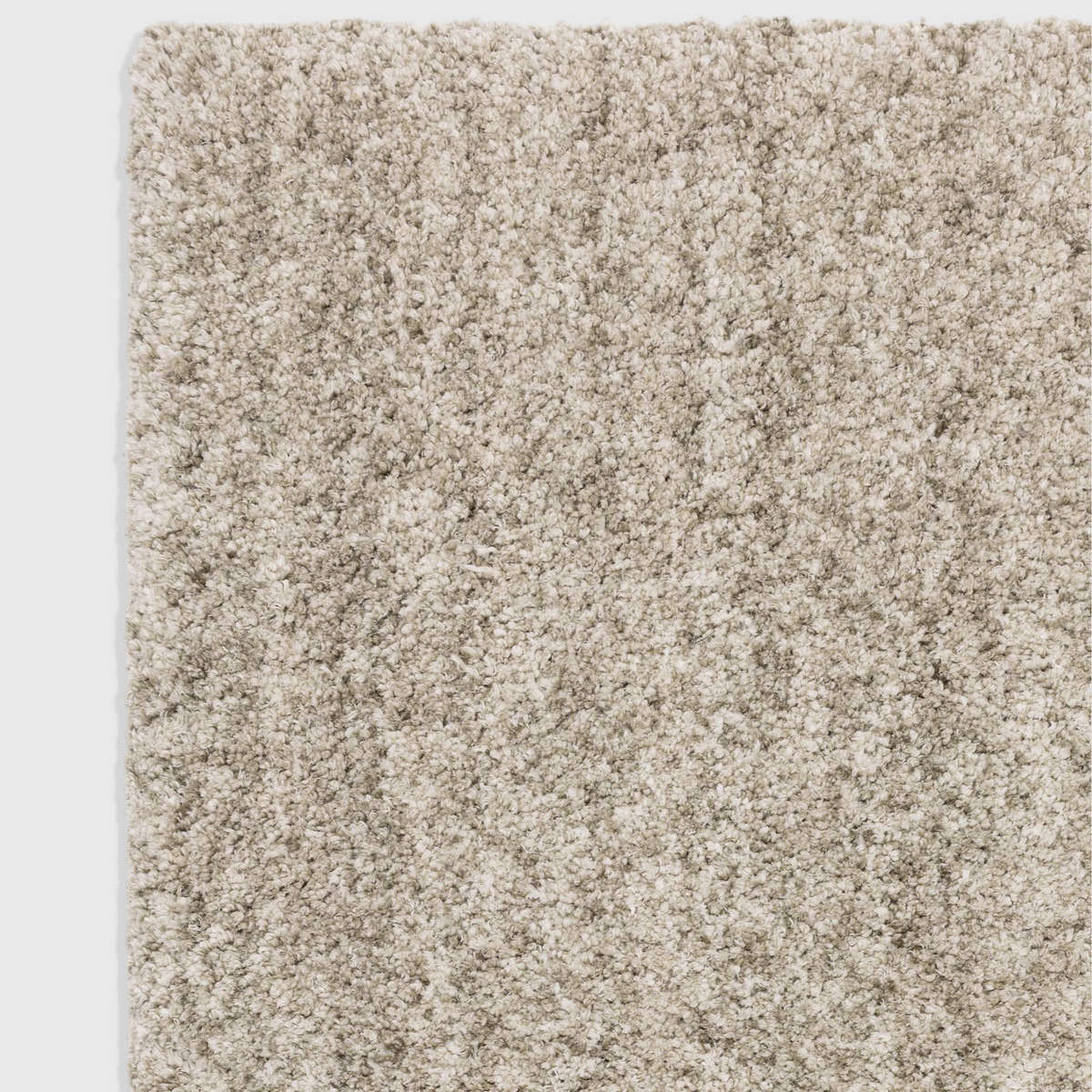 Close-up of the Alvo Rugs Barnett Sage rug featuring a soft, deep shaggy pile in muted green and neutral tones.