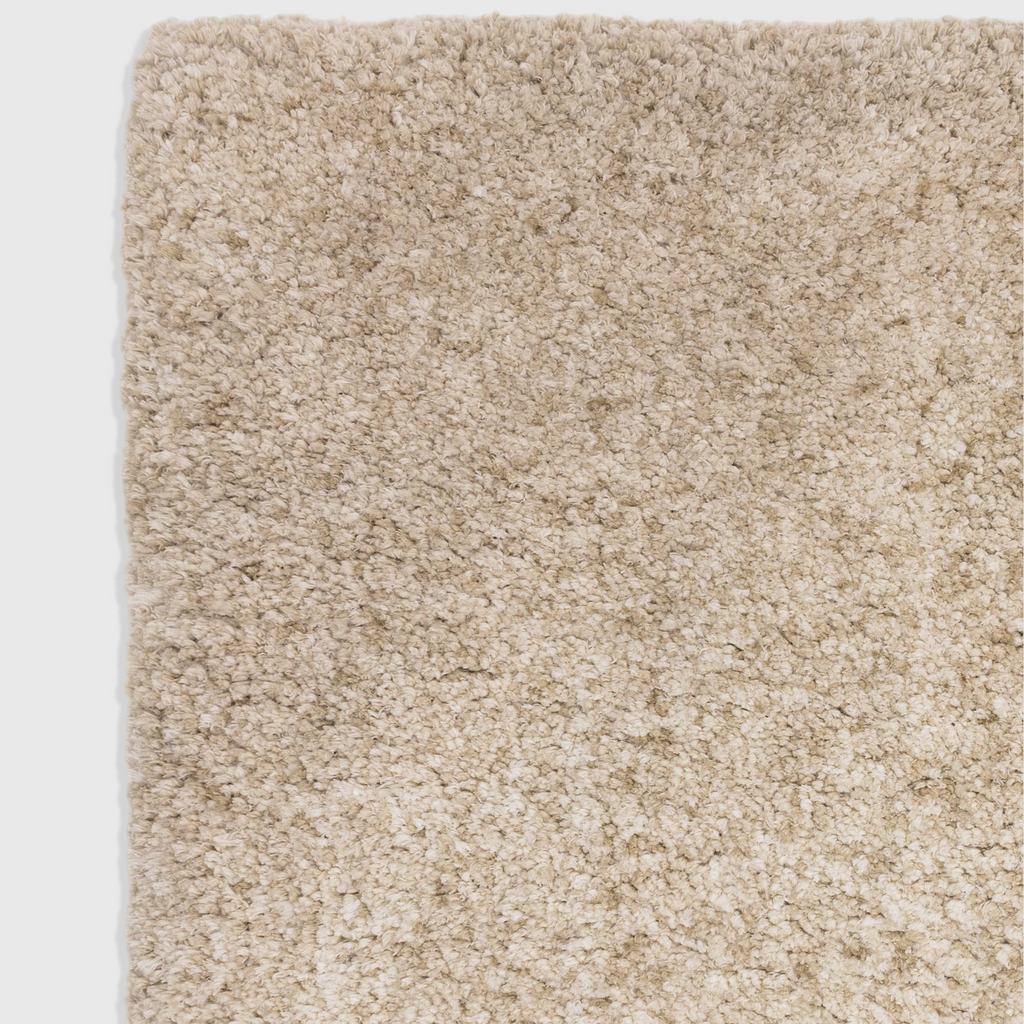 Alvo Rugs Barnett sand-coloured shaggy rug with a deep, soft microfibre polyester pile and hand-woven texture.