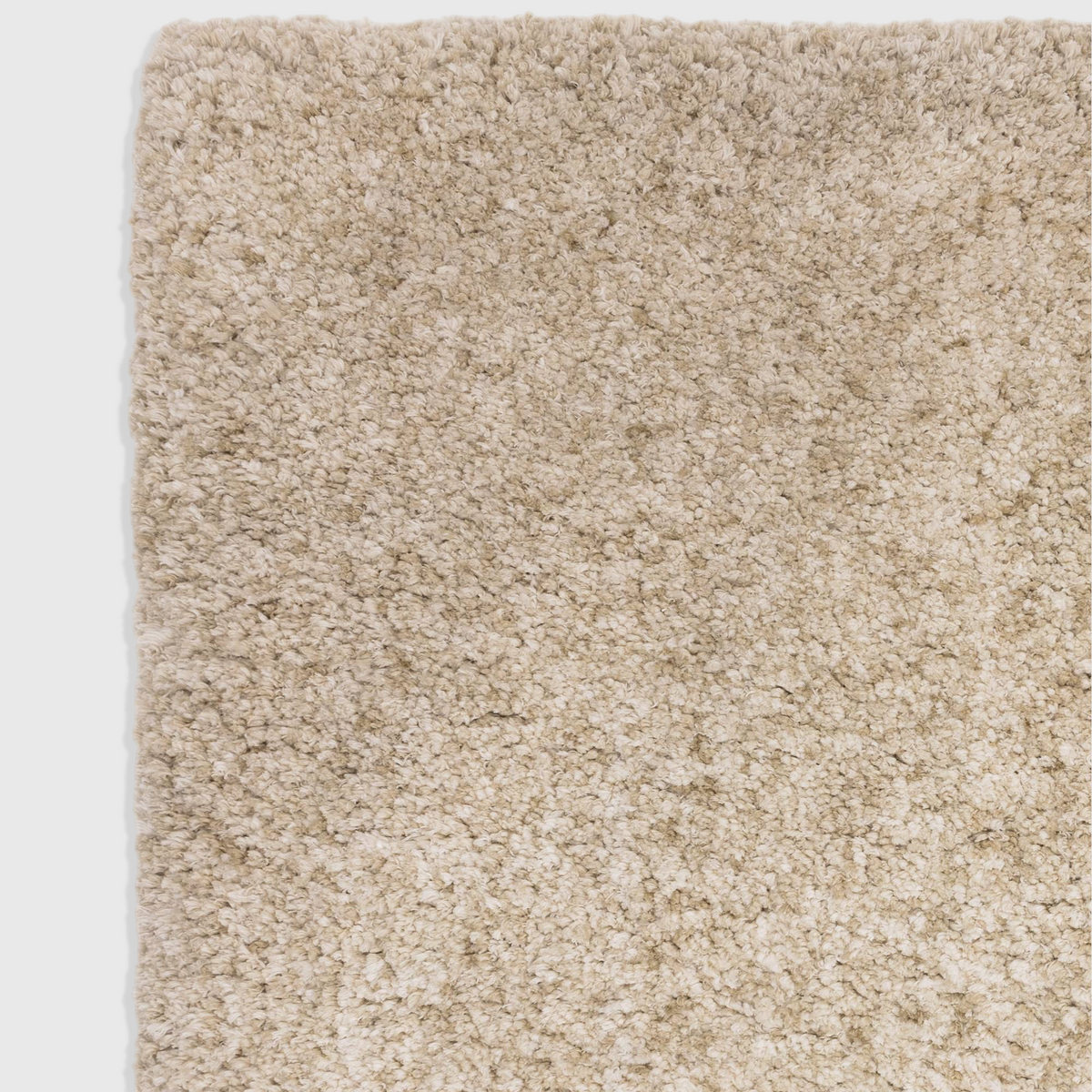 Alvo Rugs Barnett sand-coloured shaggy rug with a deep, soft microfibre polyester pile and hand-woven texture.