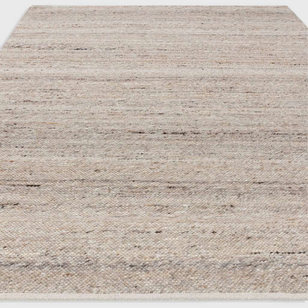 Alvo Rugs Birkley beige hand-woven flatweave rug with natural wool and polyester texture and subtle colour striations.