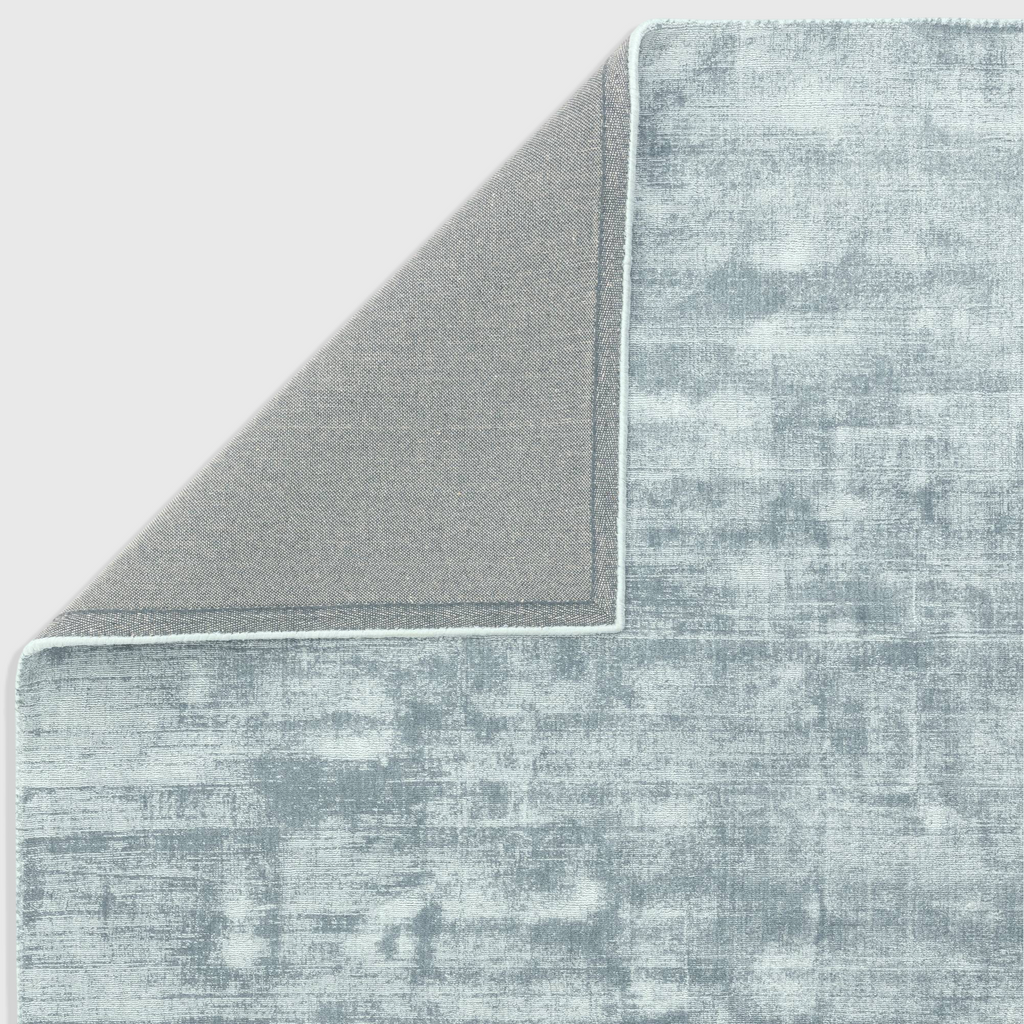 Alvo Rugs Blayde airforce blue hand-woven viscose rug showing the textured surface and grey backing corner detail.