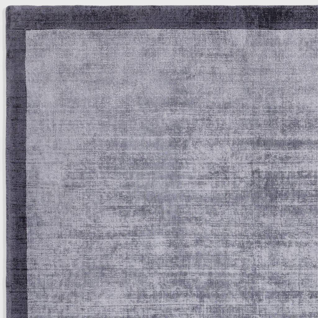 Alvo Rugs Blayde hand woven viscose rug in airforce and navy blue with a two-tone border and soft tip-sheared finish.
