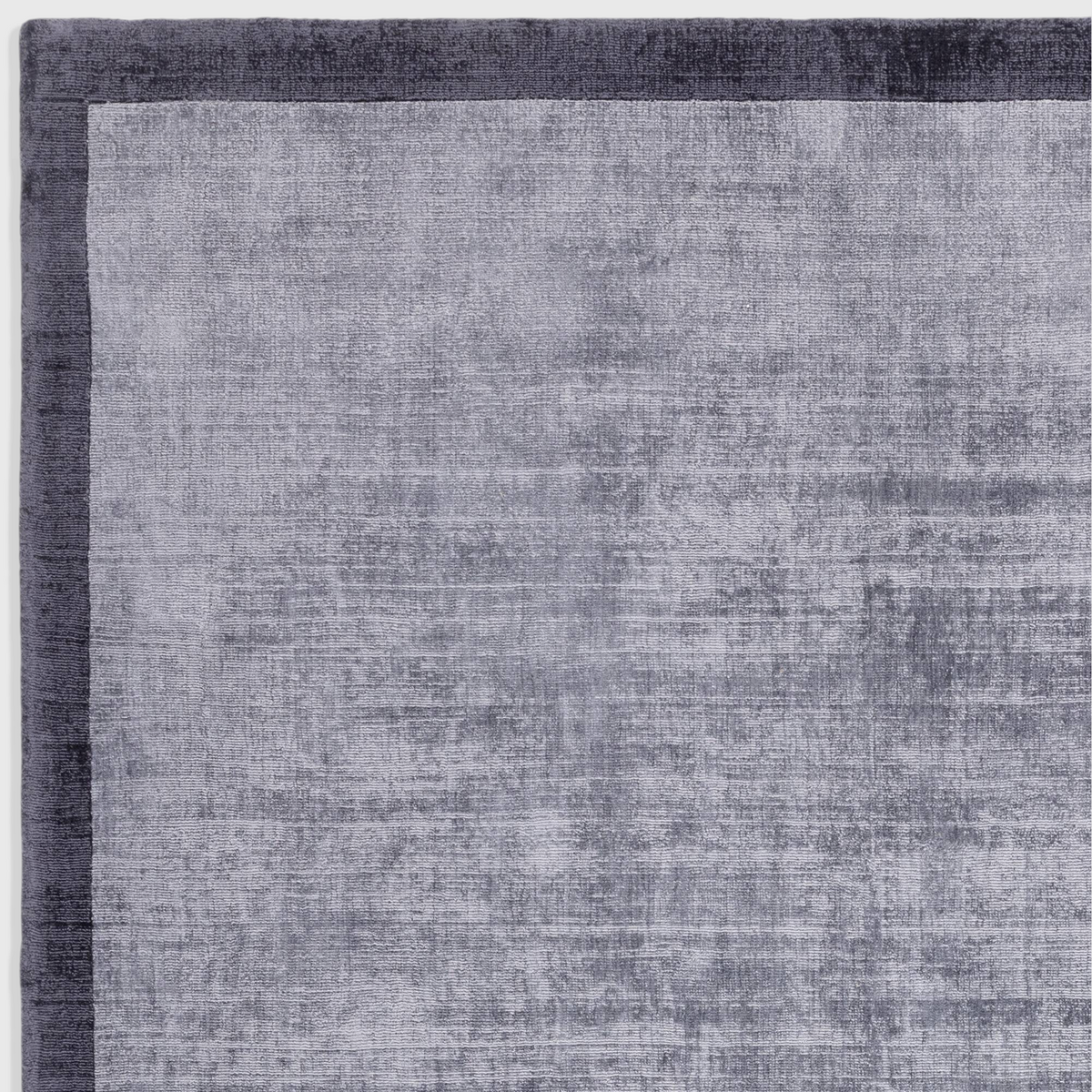 Alvo Rugs Blayde hand woven viscose rug in airforce and navy blue with a two-tone border and soft tip-sheared finish.