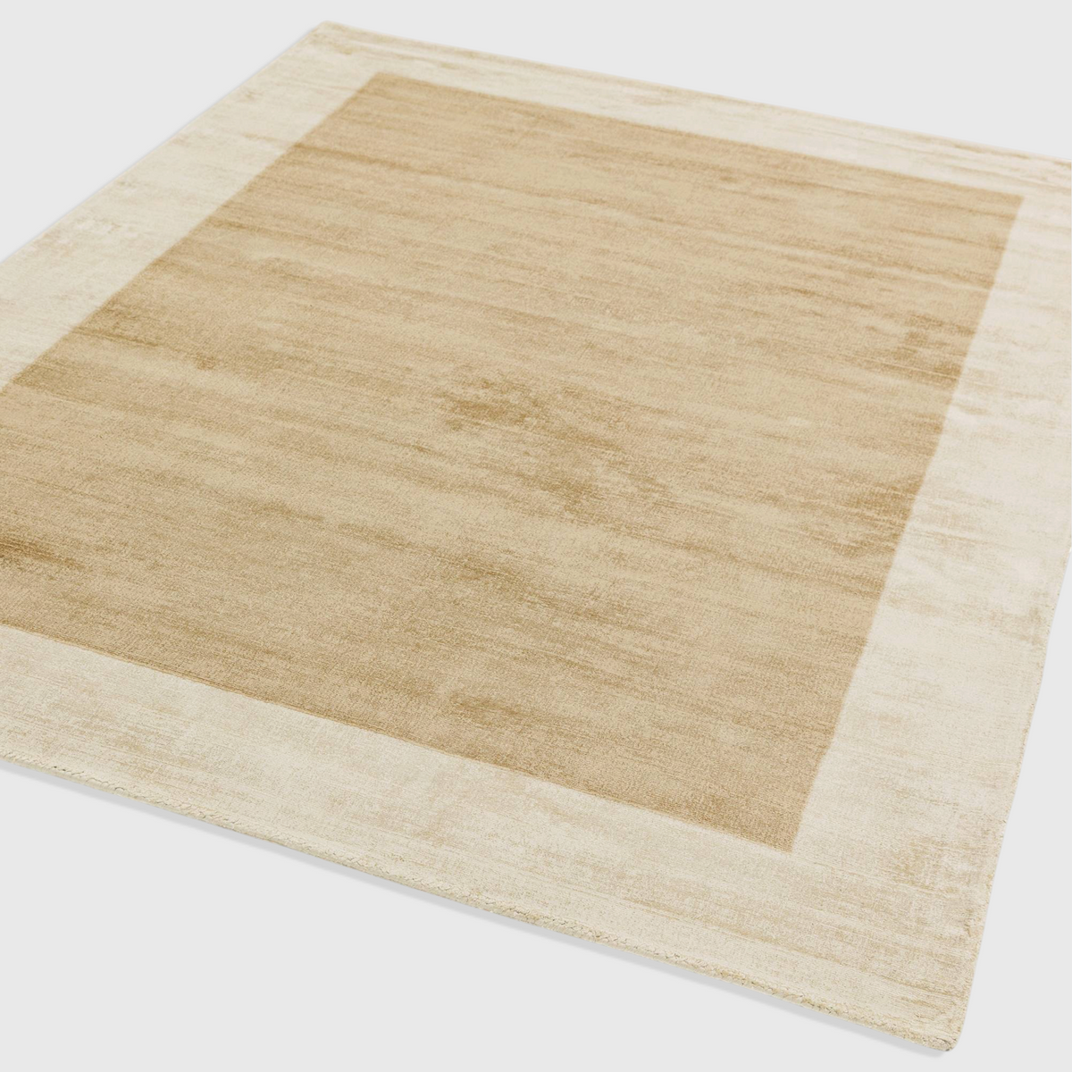 Alvo Rugs Blayde handwoven viscose rug in putty and champagne with a contrasting border and tip-sheared texture.