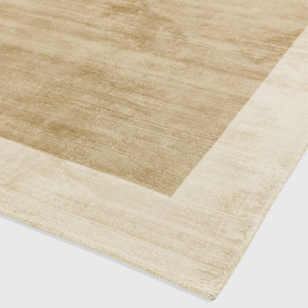 Alvo Rugs Blayde handwoven viscose rug in putty and champagne with a thick contrasting border and tip-sheared detail.