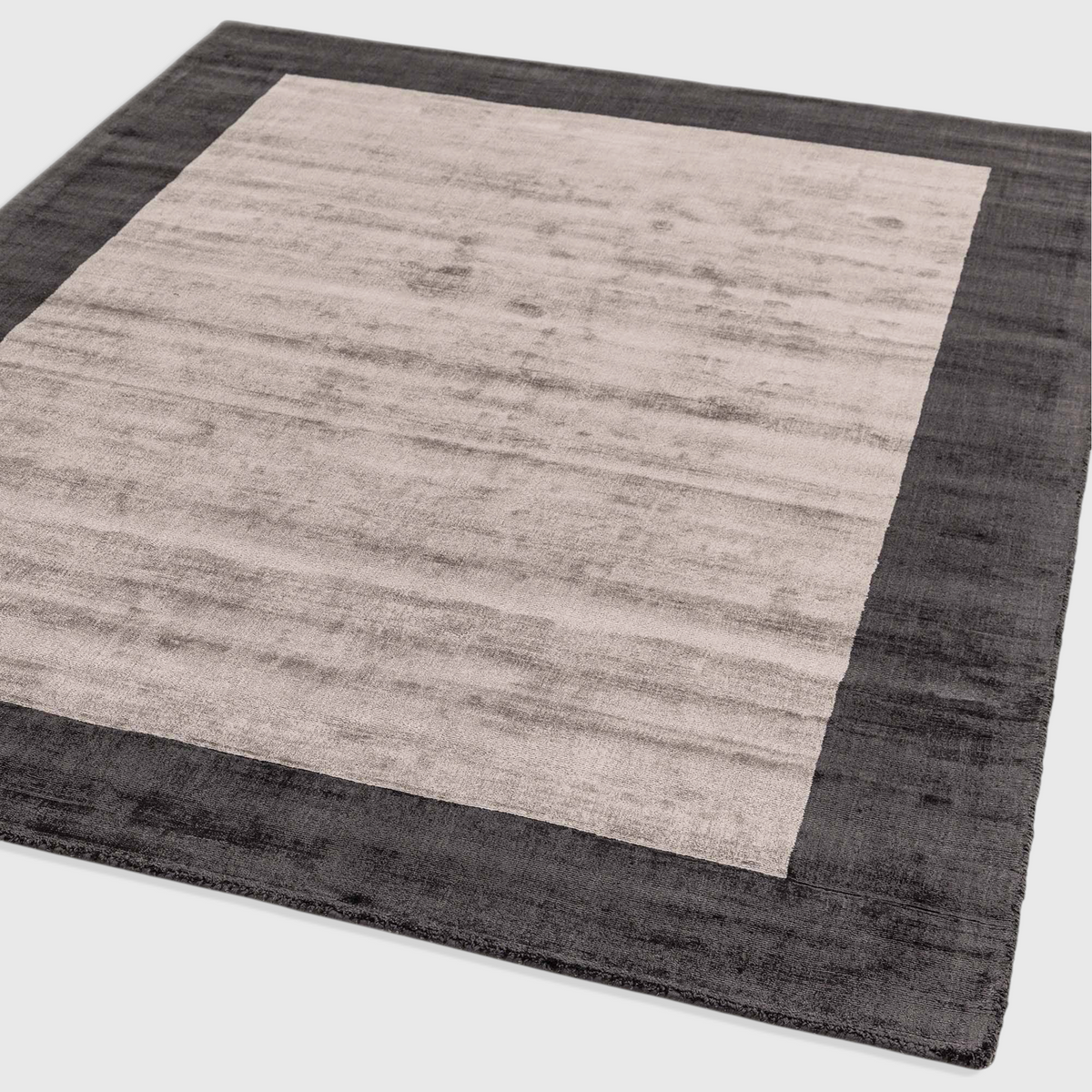 Alvo Rugs Blayde charcoal and silver handwoven viscose rug with a thick contrasting border and tip-sheared finish.