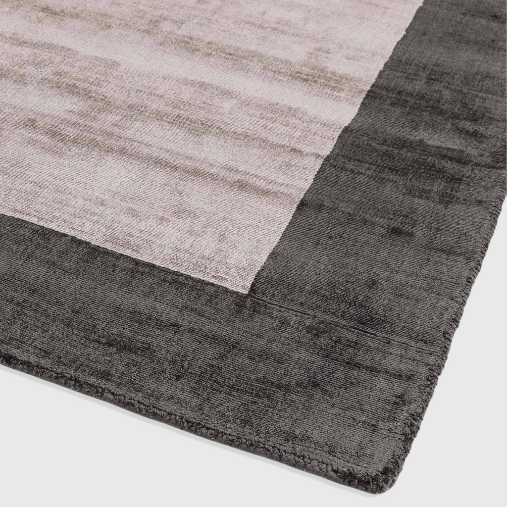 Alvo Rugs Blayde charcoal and silver handwoven viscose rug with a thick contrasting border and tip-sheared texture.