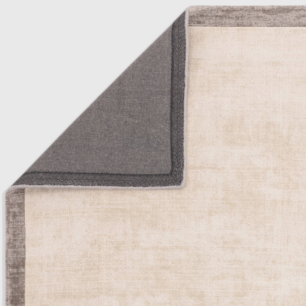Alvo Rugs Blayde Putty and silver viscose rug showing the dark grey latex backing and corner detail