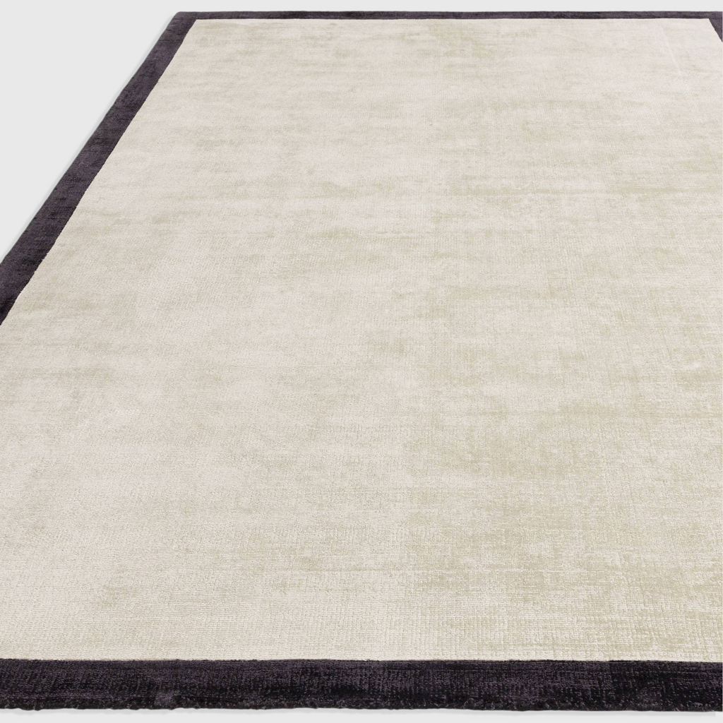 Alvo Rugs Blayde hand woven viscose rug in putty and charcoal with a two-tone border design.