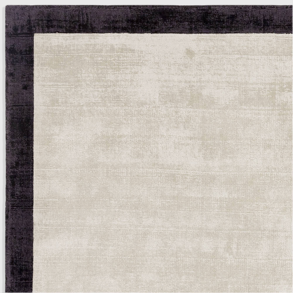 Alvo Rugs Blayde hand-woven viscose rug in putty and charcoal with a dark border and soft tip-sheared texture.