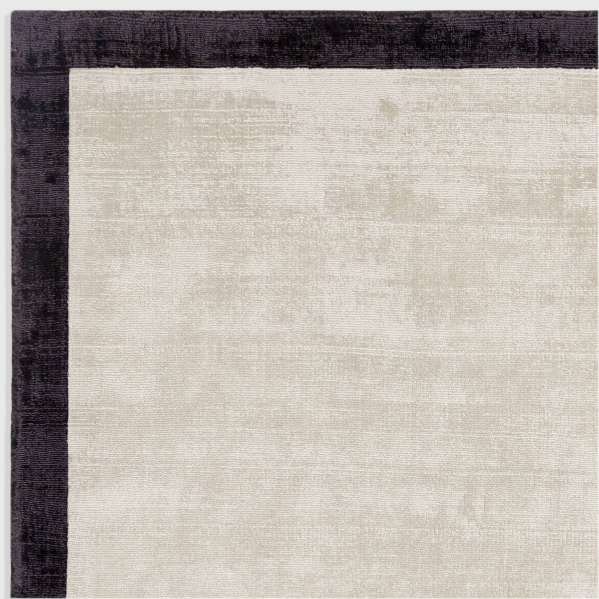Alvo Rugs Blayde hand-woven viscose rug in putty and charcoal with a dark border and soft tip-sheared texture.