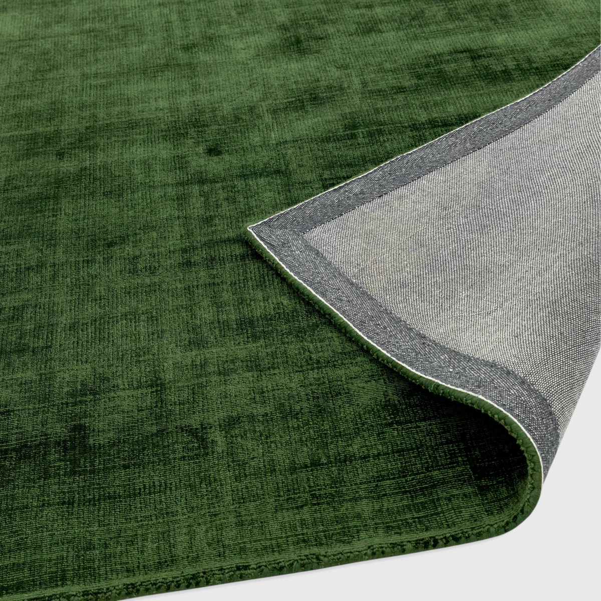 Alvo Rugs Blayde green hand-woven viscose rug showing the textured top surface and the durable latex backing