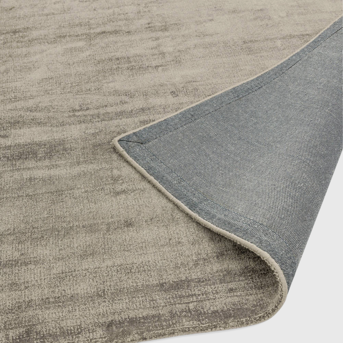Alvo Rugs Blayde mocha viscose rug showing the textured beige surface and the grey latex backing detail