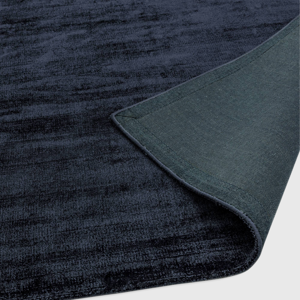Alvo Rugs Blayde navy blue hand-woven viscose rug showing the soft pile texture and durable latex backing detail.