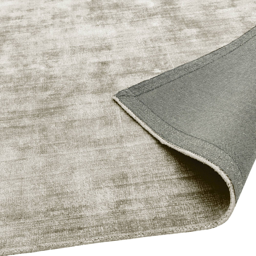Alvo Rugs Blayde Smoke rug in grey viscose with a hand-woven texture and durable latex backing shown from the corner.