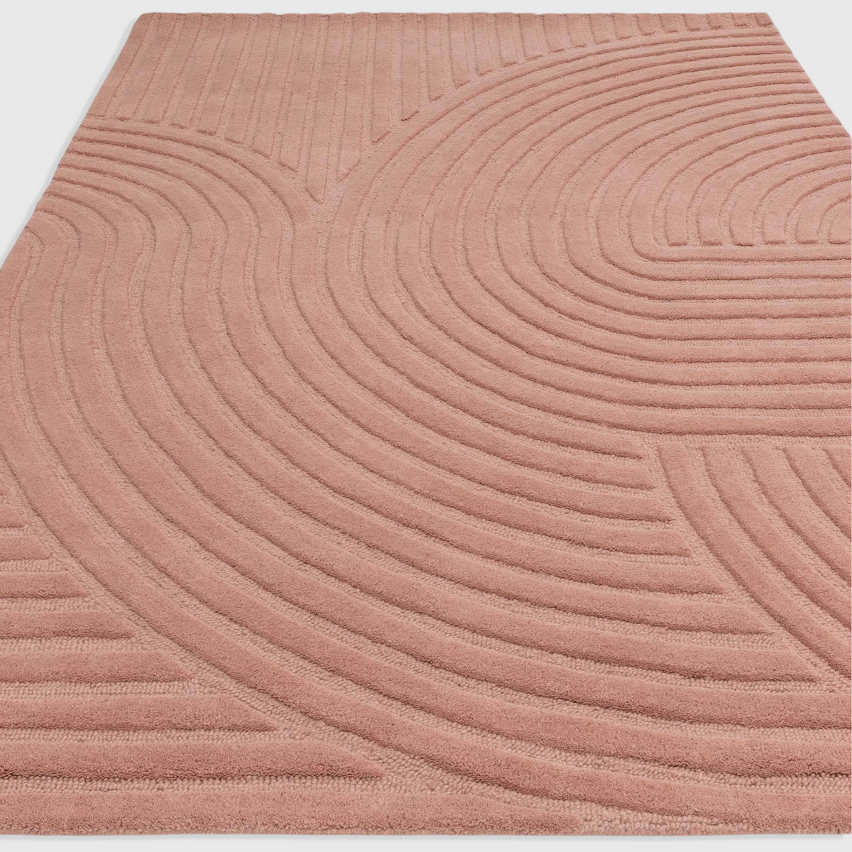 Alvo Rugs Hagia Blush rug featuring a geometric cut and loop wool pile in soft pink tones with curved line patterns.