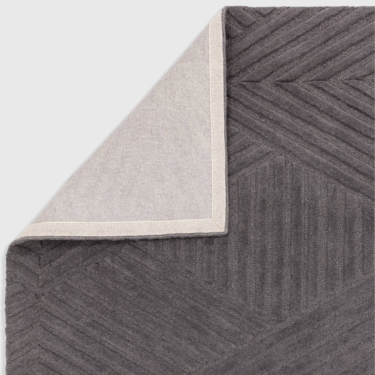 Alvo Rugs Hagia charcoal grey wool rug with geometric cut and loop texture and cotton backing detail