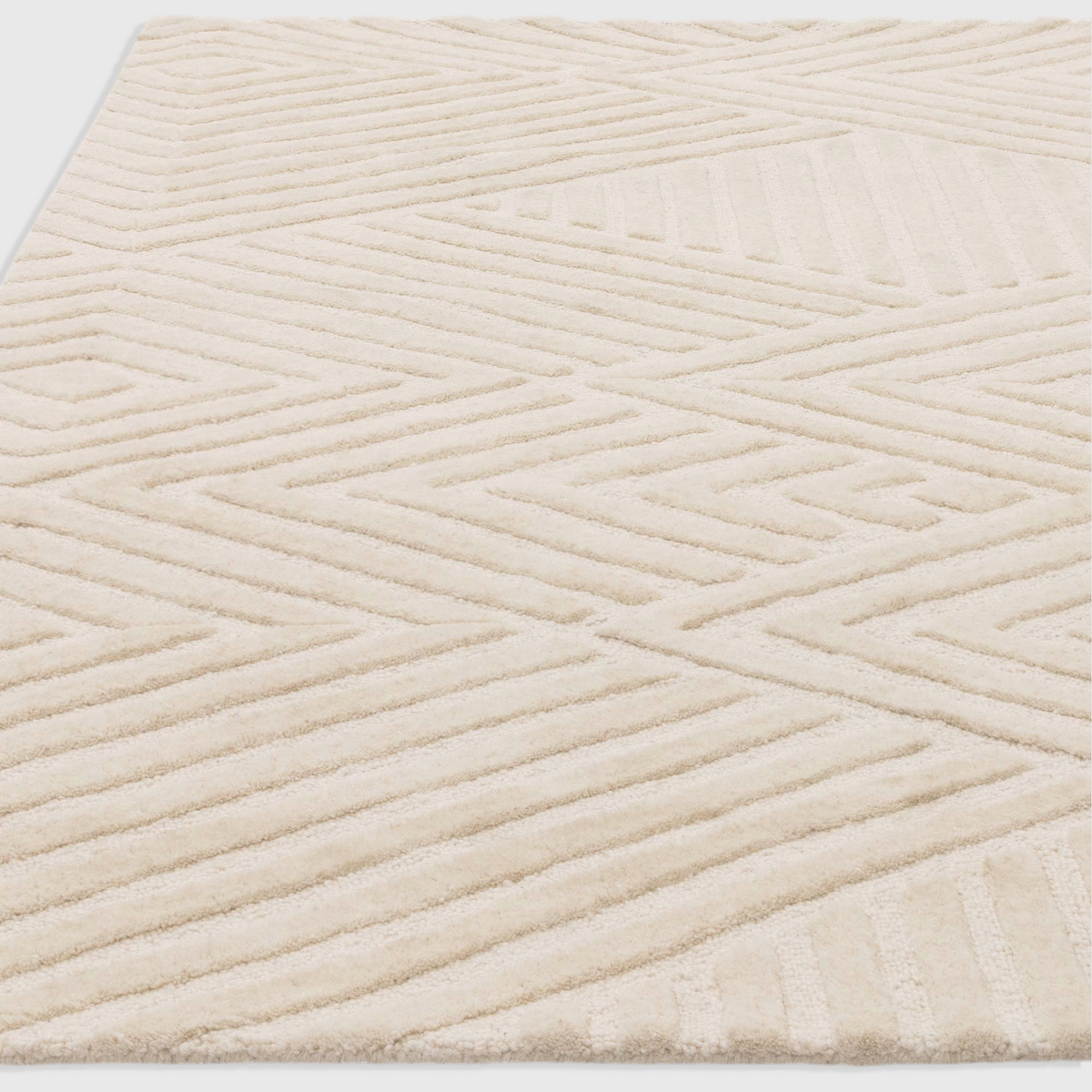 Alvo Rugs Hagia ivory wool rug with geometric cut and loop pile texture in a contemporary hand tufted design.