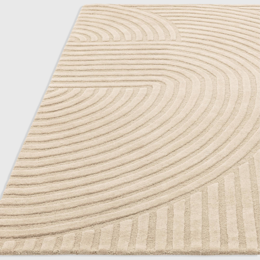 Alvo Rugs Hagia Sand rug featuring a beige geometric cut and loop wool pile with sweeping curved lines.