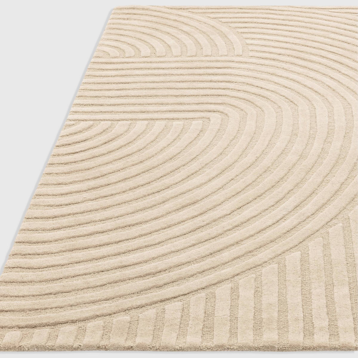 Alvo Rugs Hagia Sand rug featuring a beige geometric cut and loop wool pile with sweeping curved lines.