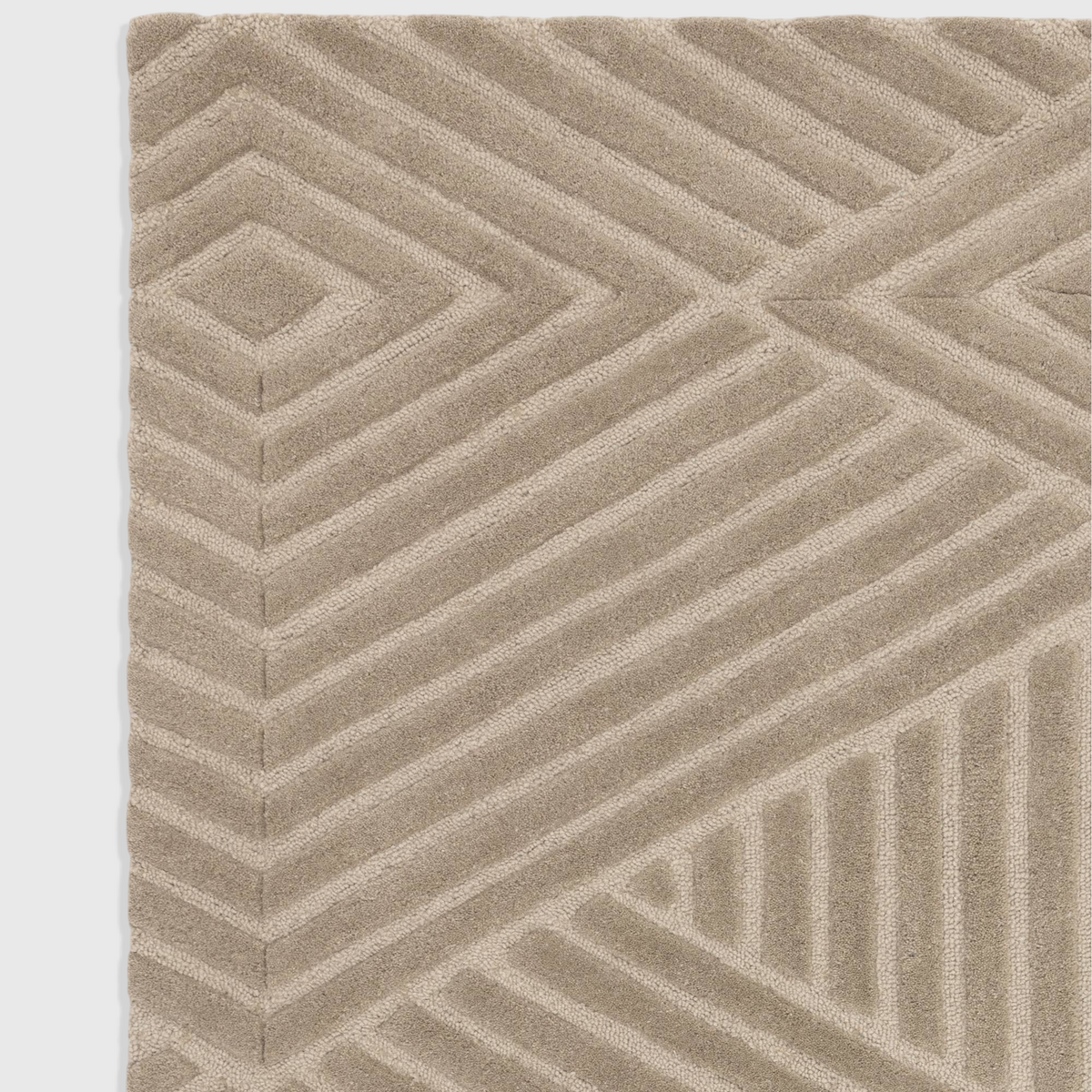 Alvo Rugs Hagia taupe wool rug with a geometric cut and loop pile pattern in a soft, textured beige finish.