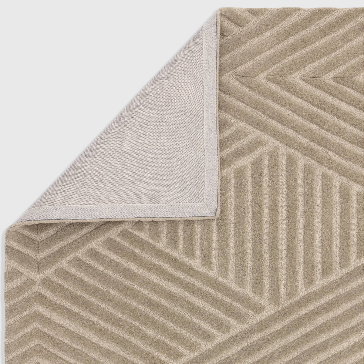 Alvo Rugs Hagia taupe wool rug with geometric cut and loop pattern, showing the cotton backing corner detail.
