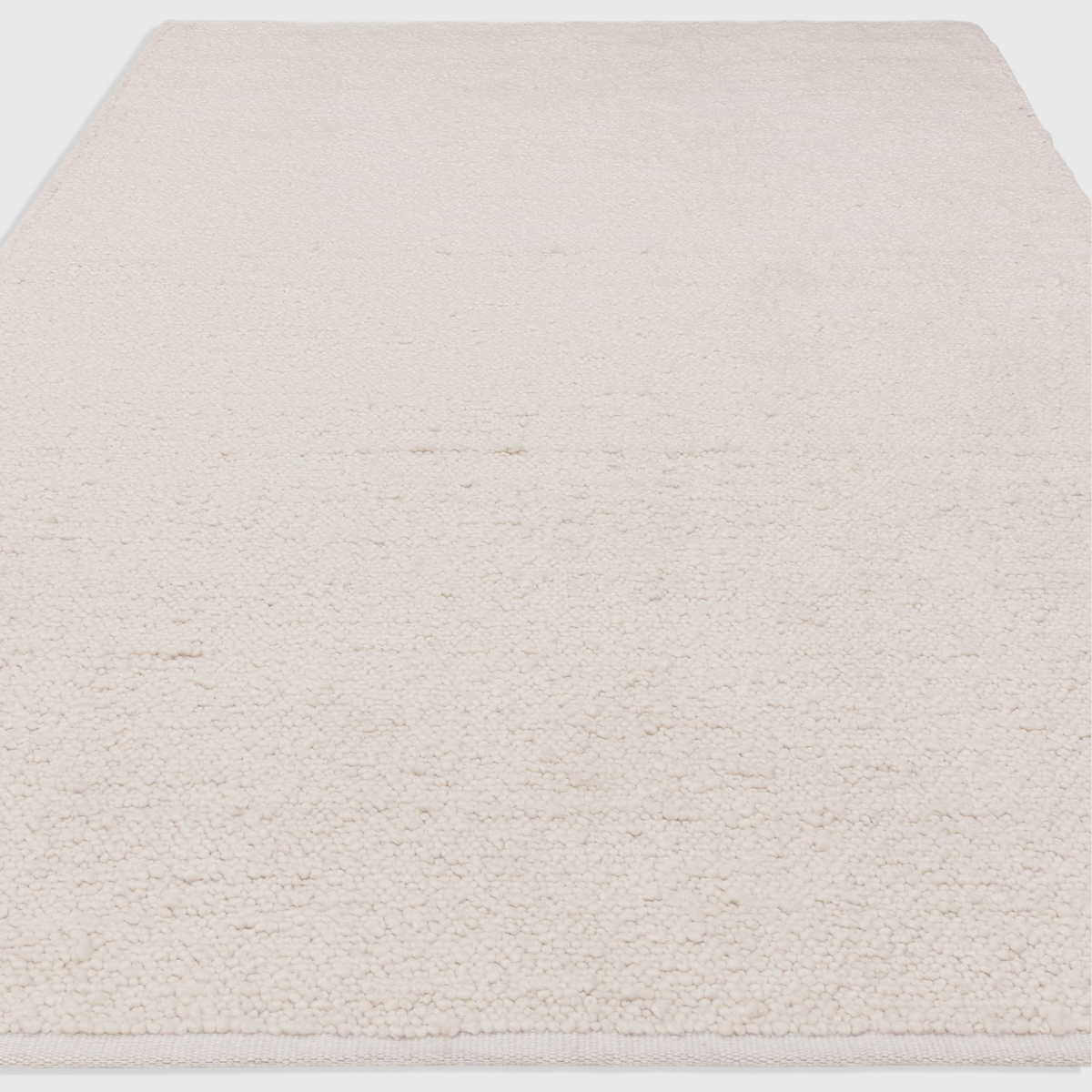 Alvo Rugs Abella ivory boucle rug with a textured hand-woven polyester finish in a minimalist boho style
