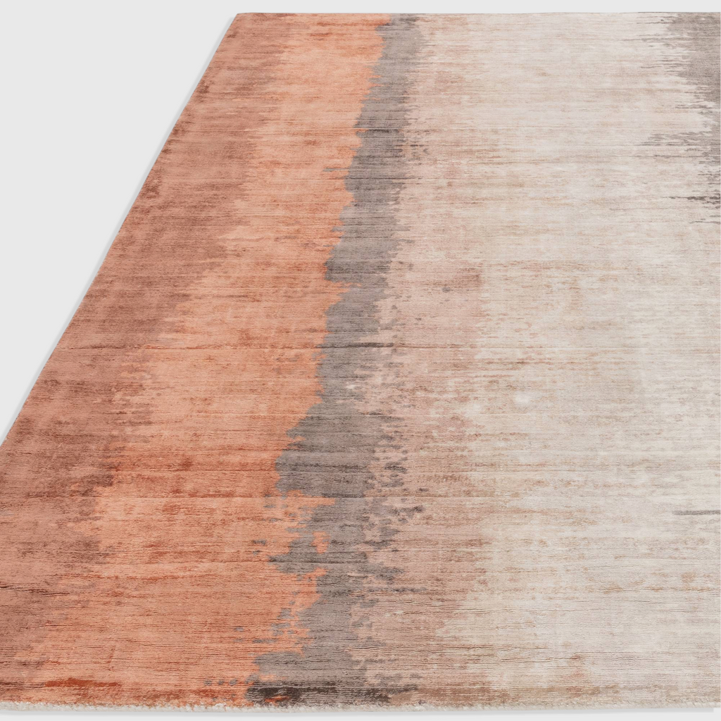 Alvo Rugs Junow Ginger rug featuring an abstract design in warm orange and grey tones, hand woven from soft viscose.