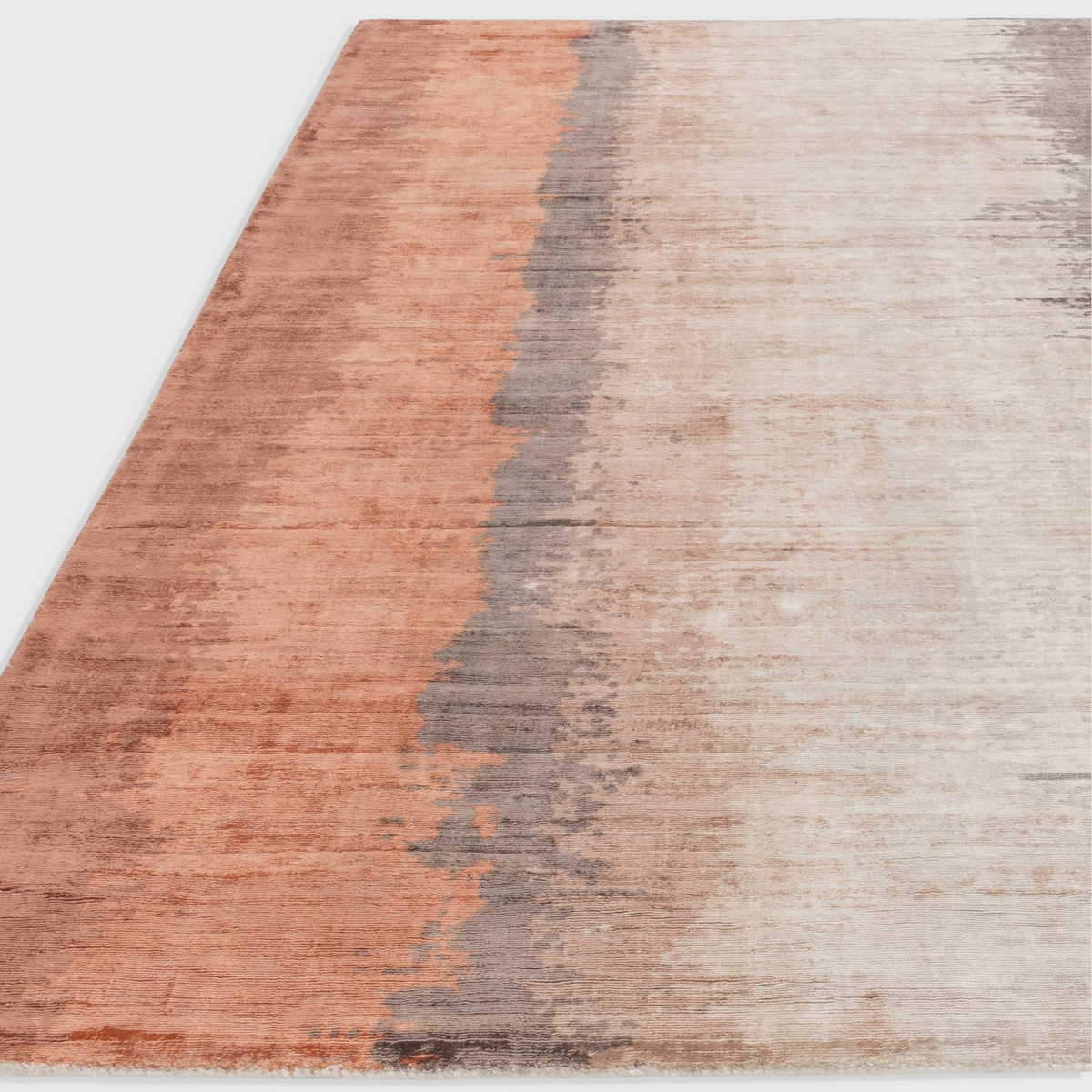 Alvo Rugs Junow Ginger rug featuring an abstract design in warm orange and grey tones, hand woven from soft viscose.