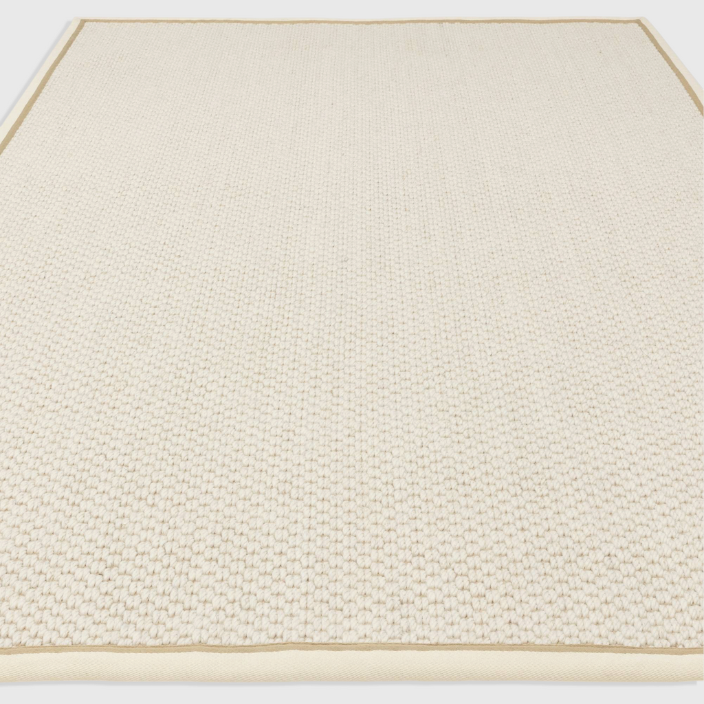 Alvo Rugs Kori cream linen rug featuring a textured double loop wool and jute flatweave with a cotton border.