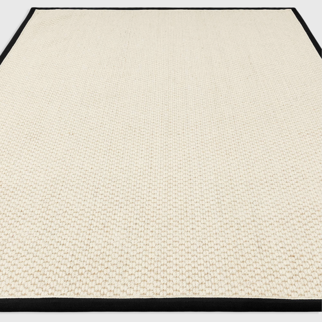 Alvo Rugs Kori charcoal and cream wool and jute rug with a textured double loop pile and a dark cotton border.