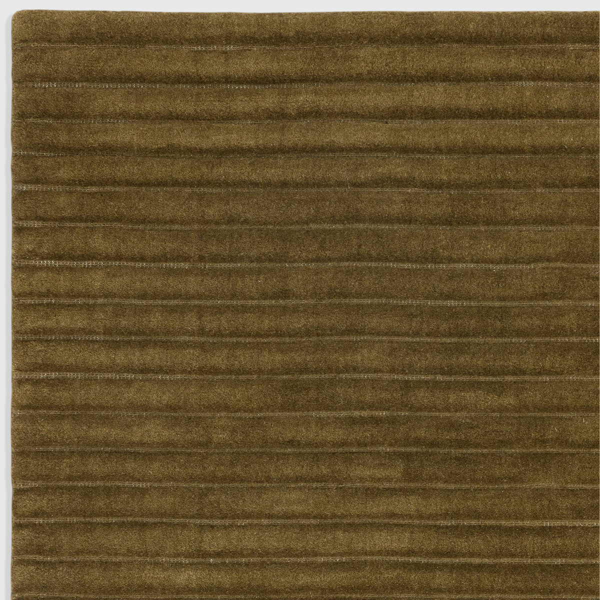 Alvo Rugs Lina Forest green wool rug featuring a textured high-low pile with horizontal ridged stripes.