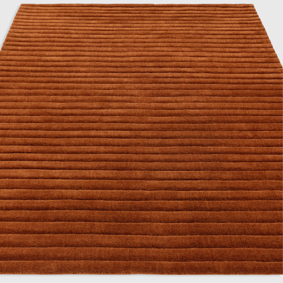 Alvo Rugs Lina rust orange hand-woven wool rug with a textured high-low ridged pile design.